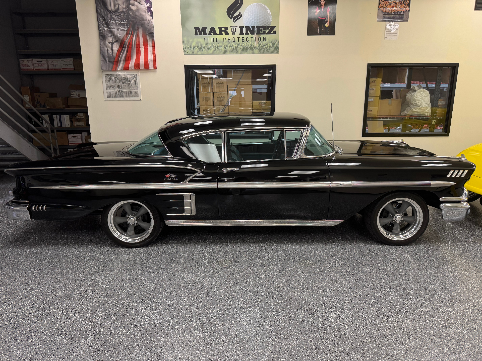 Black Chevrolet Impala side profile in the shop